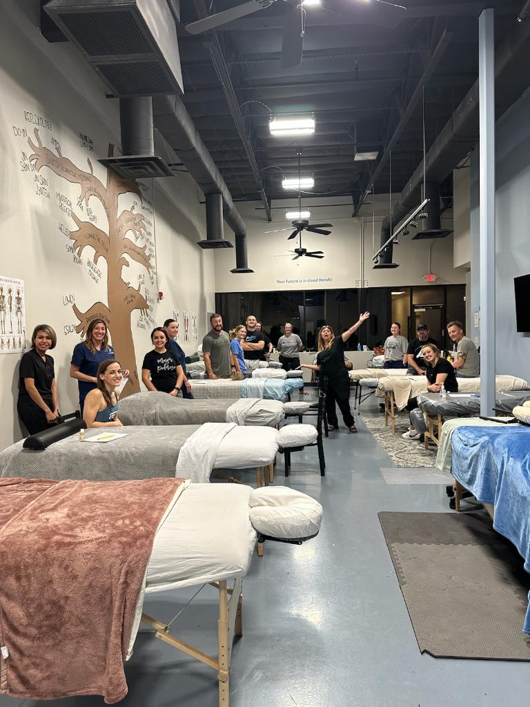 A group of people sitting in beds inside of a room.