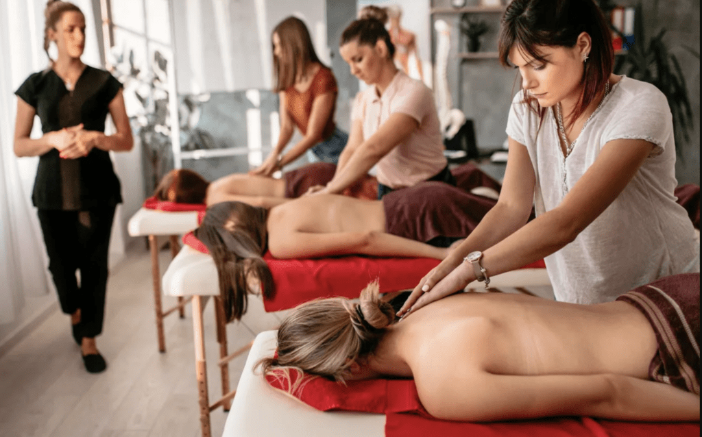 A group of women are getting their backs waxed.