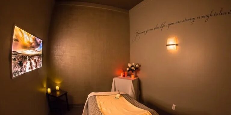 A room with a bed and candles on the wall