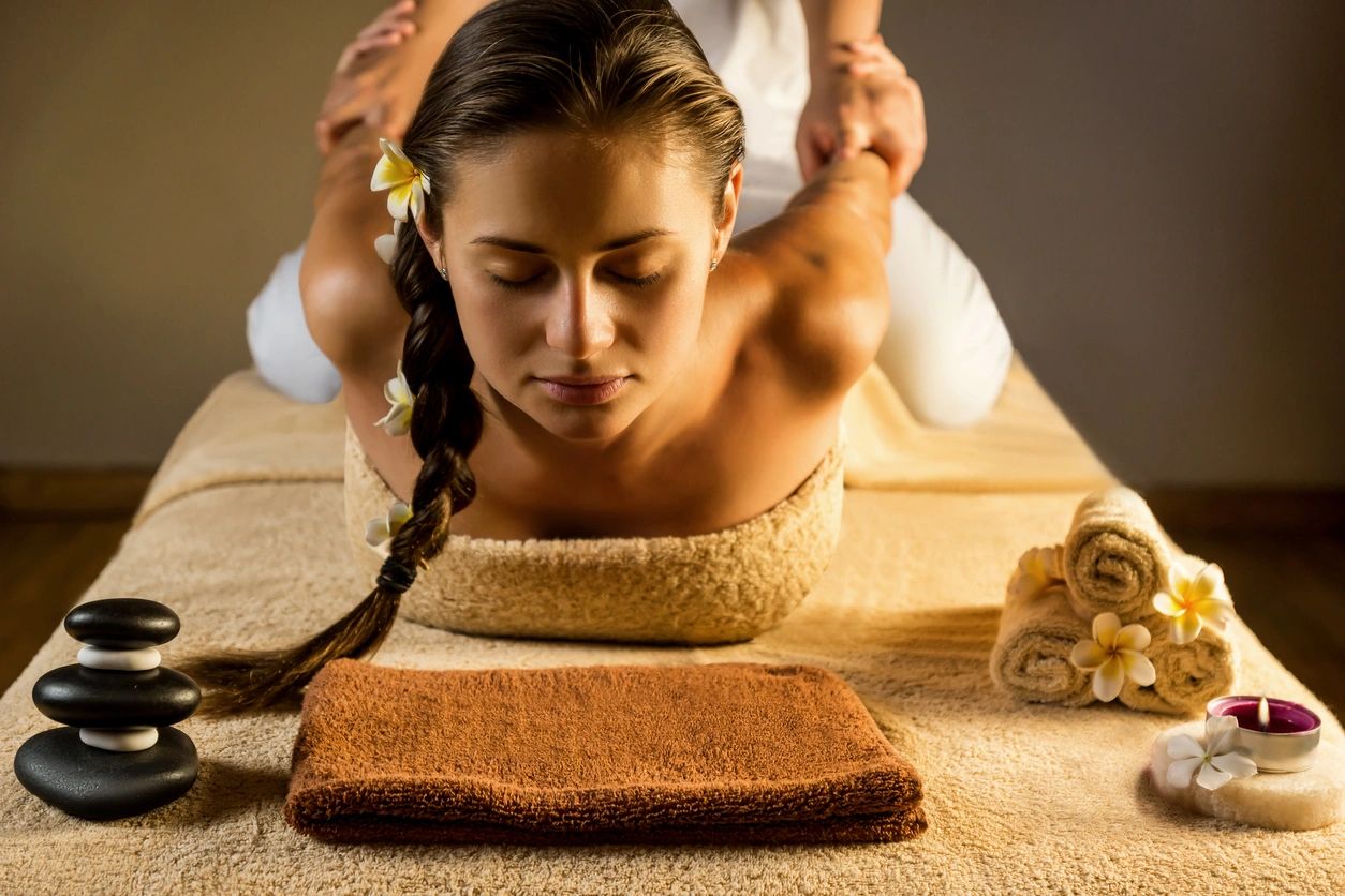 A woman laying on the floor getting her hair combed.