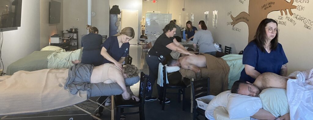 A group of people sitting in chairs at a salon.